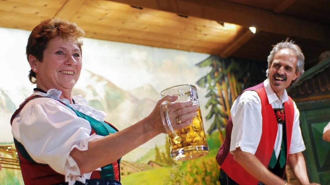 Traditional Tyrolean performers with beer stein at Gundolf Family Folk Show.