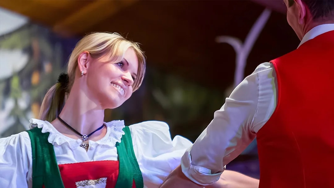 Dancers in traditional Tyrolean attire performing at the Gundolf Family Folk Show.