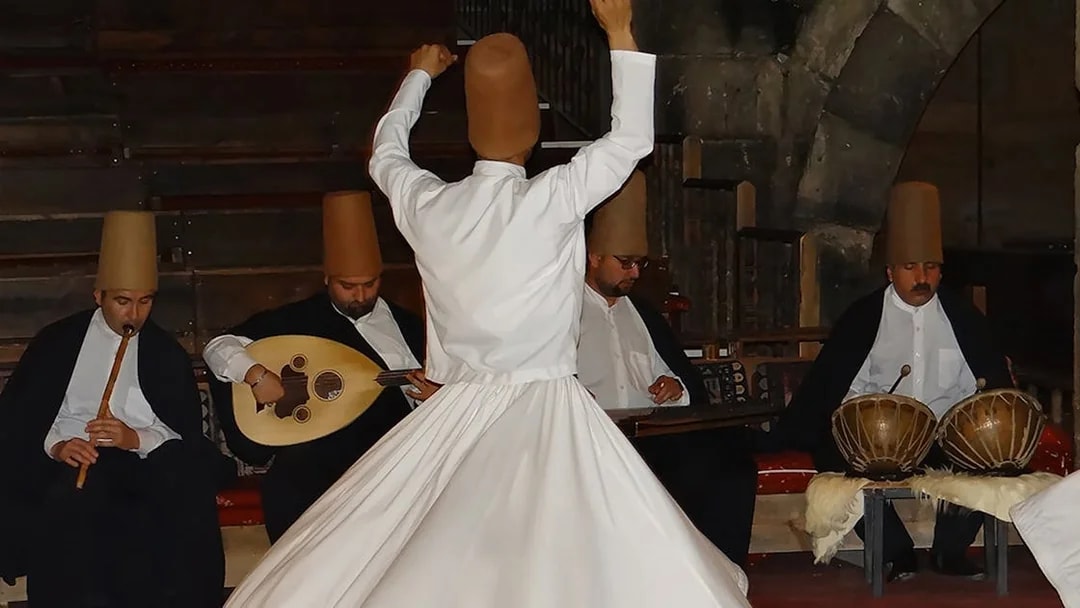 Whirling Dervish performing with musicians in Cappadocia.