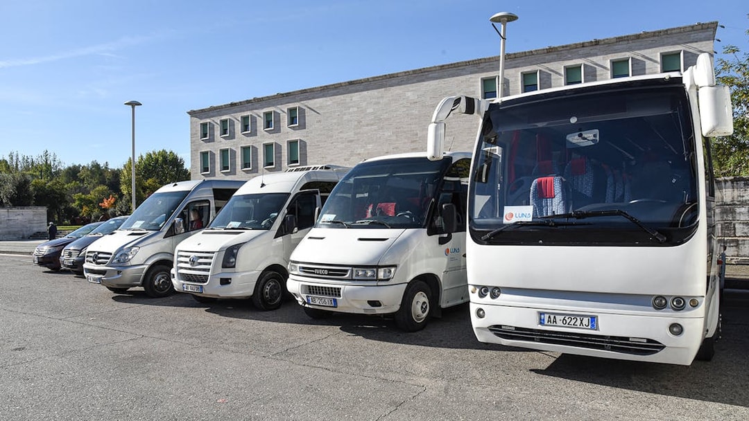 Buses parked at Tirana Airport for transfers to Tirana Central.