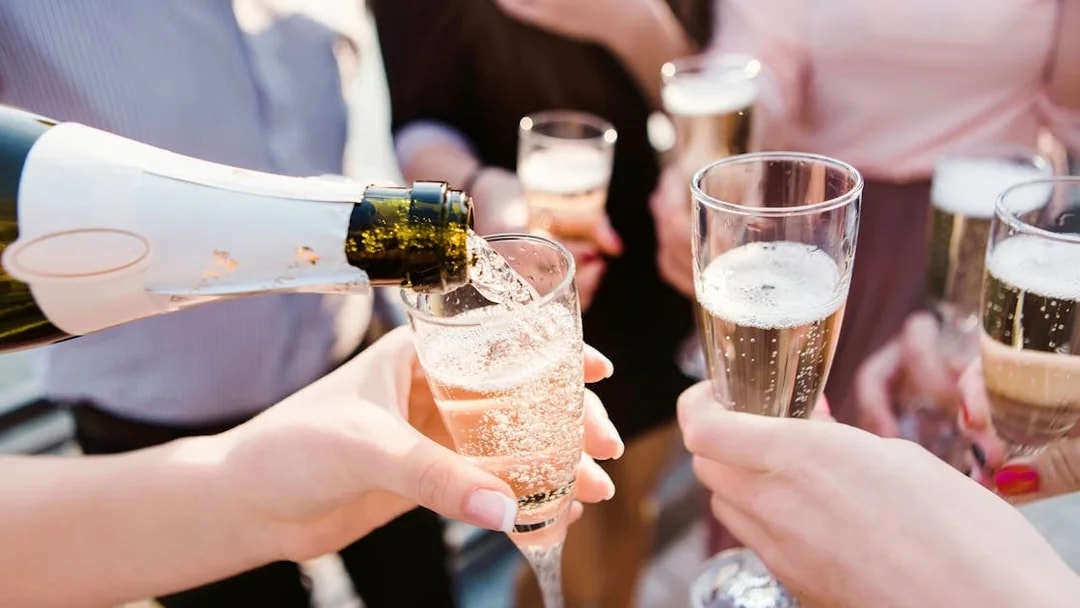 Pouring champagne into glasses during Blue Cave & Our Lady of The Rock boat tour.