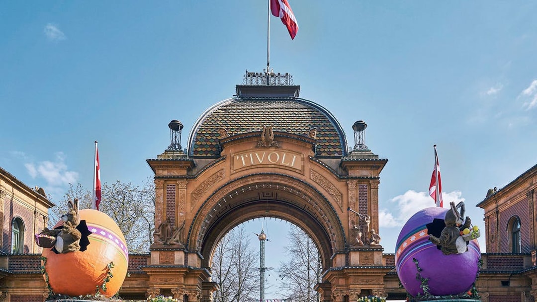 Tivoli Gardens entrance with decorative eggs and Danish flags in Copenhagen.