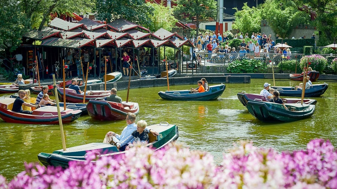 Boats with visitors on a pond at Tivoli Gardens, Copenhagen.