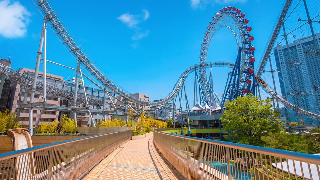 Roller coaster at Tokyo Dome City Attractions with cityscape background.