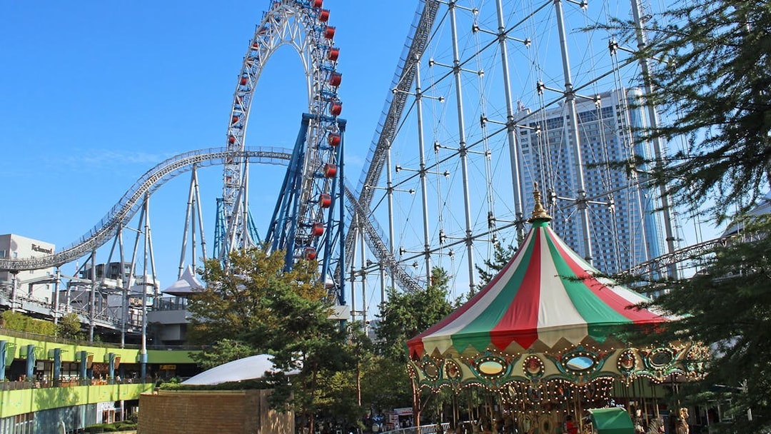 Roller coaster and carousel at Tokyo Dome City Attractions.