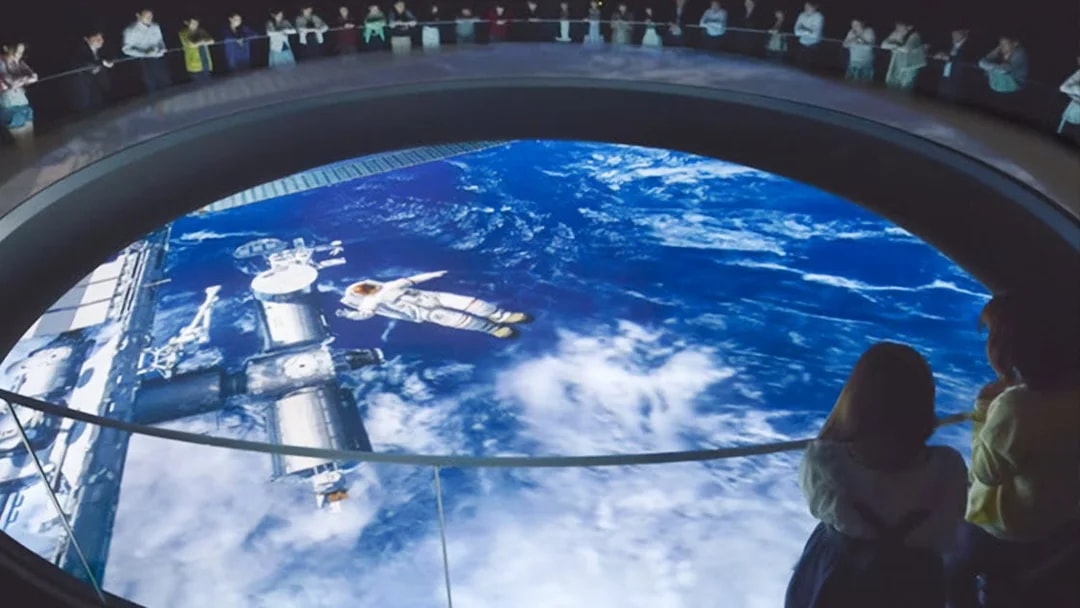 Visitors observing space exhibit at Tokyo Dome City Attractions' Space Museum TeNQ.