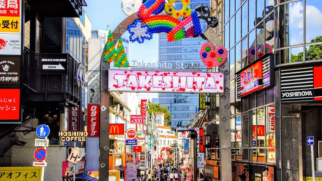 Takeshita Street entrance in Harajuku, Tokyo, bustling with shops and colorful decorations.