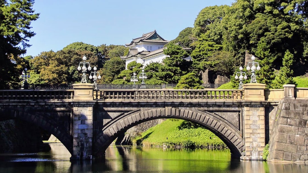 Canal and bridge near Imperial Palace Tokyo with surrounding greenery.