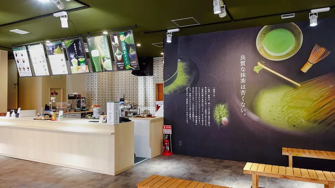 Interior of a Matcha tea shop in Tokyo with menu displays and seating area.
