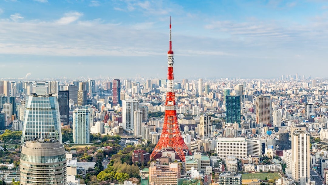 Tokyo Tower amidst city skyline in Tokyo, Japan.