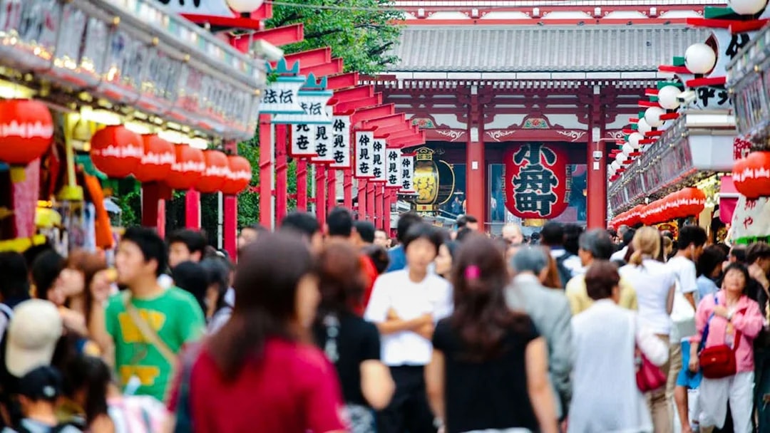 Crowds walking along Nakamise-dori towards Sensō-ji Temple in Asakusa, Tokyo, Japan.
