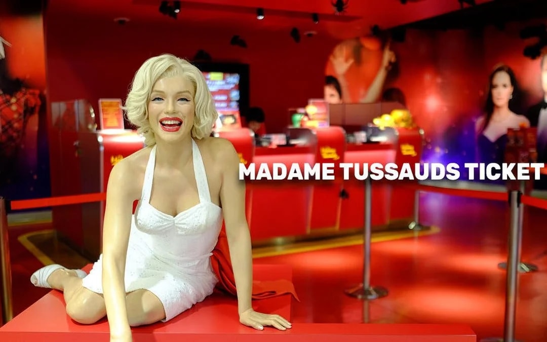 Madame Tussauds Tokyo wax figure exhibit with ticket counter in background.