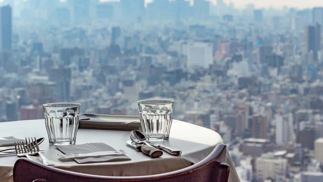 Dining table set with cityscape view from Tokyo Skytree restaurant.
