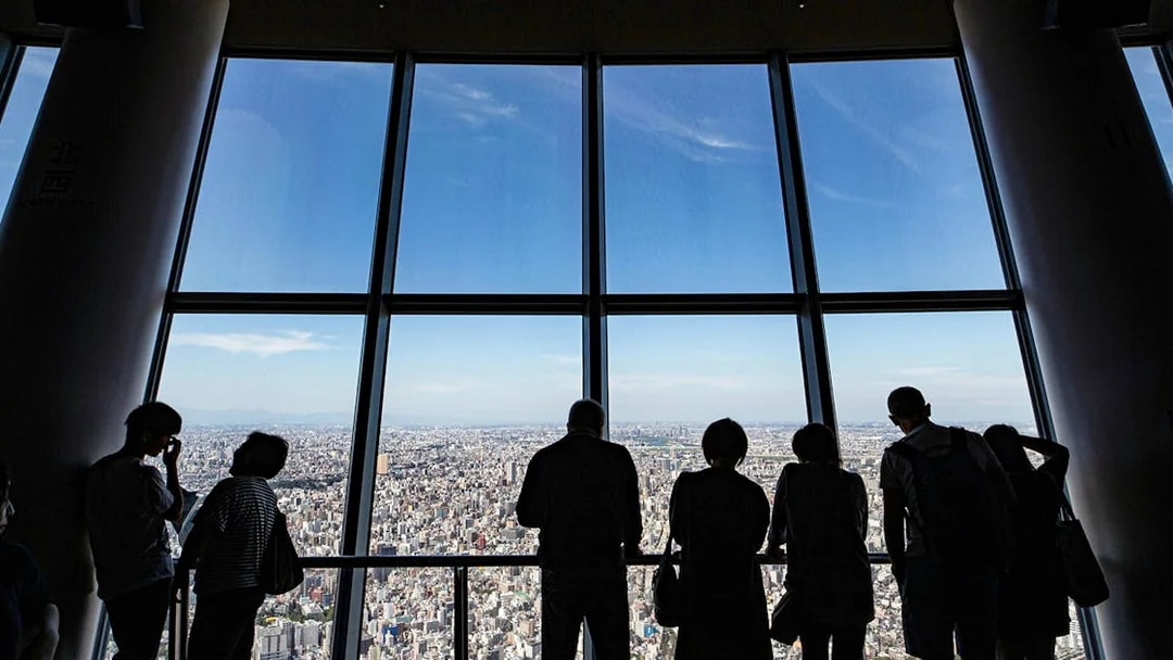 Visitors enjoying city views from Tokyo Skytree Viewing Deck.