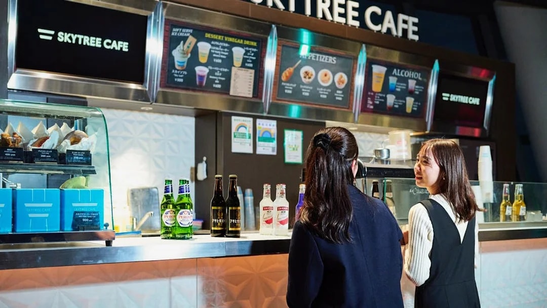 Tourists ordering drinks at Skytree Cafe Tembo deck.