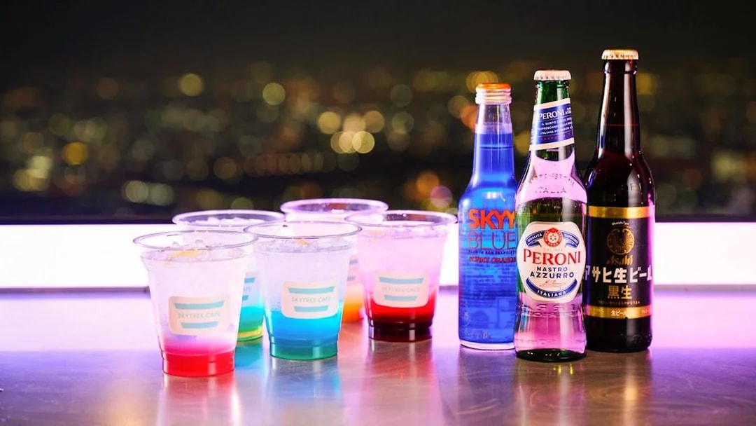 Drinks on a table with a city night view from Tembo Deck.