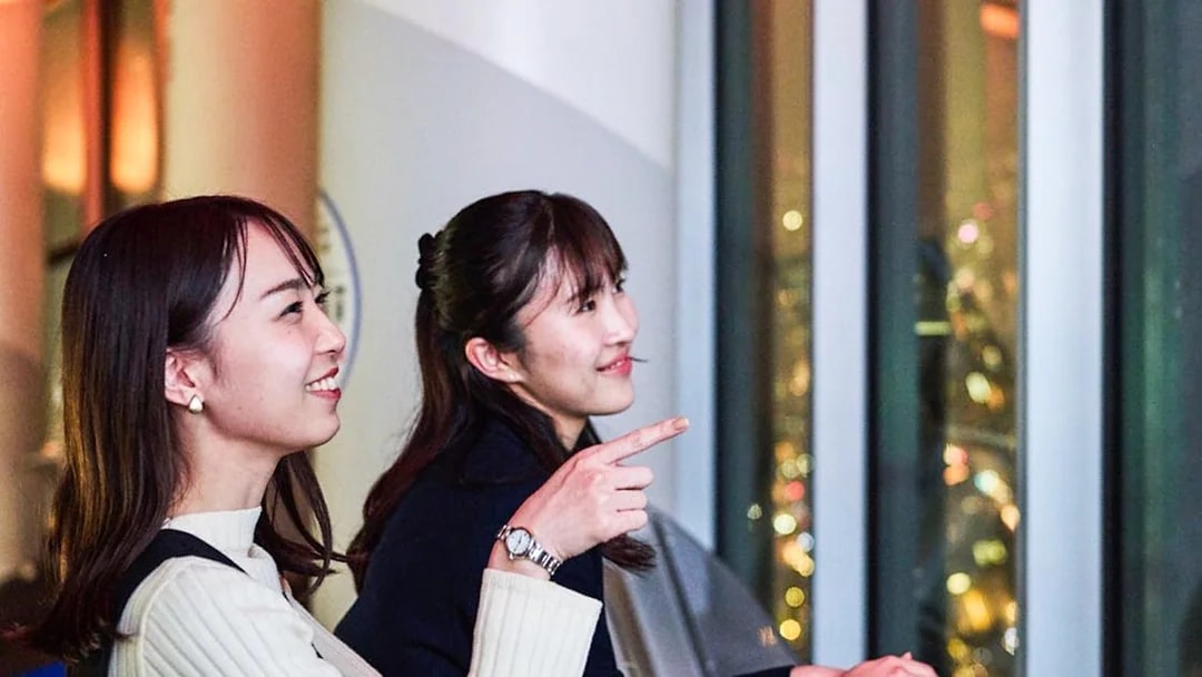 Tourists enjoying Tokyo night skyline from Tembo Deck.