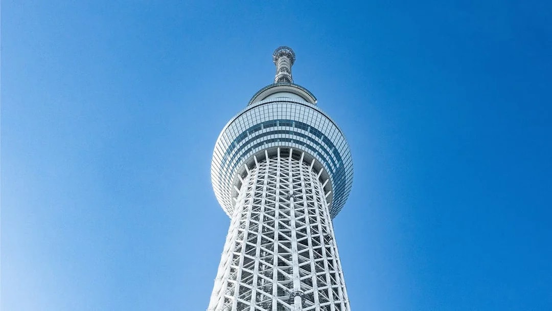 Tokyo Skytree tower against a clear blue sky.