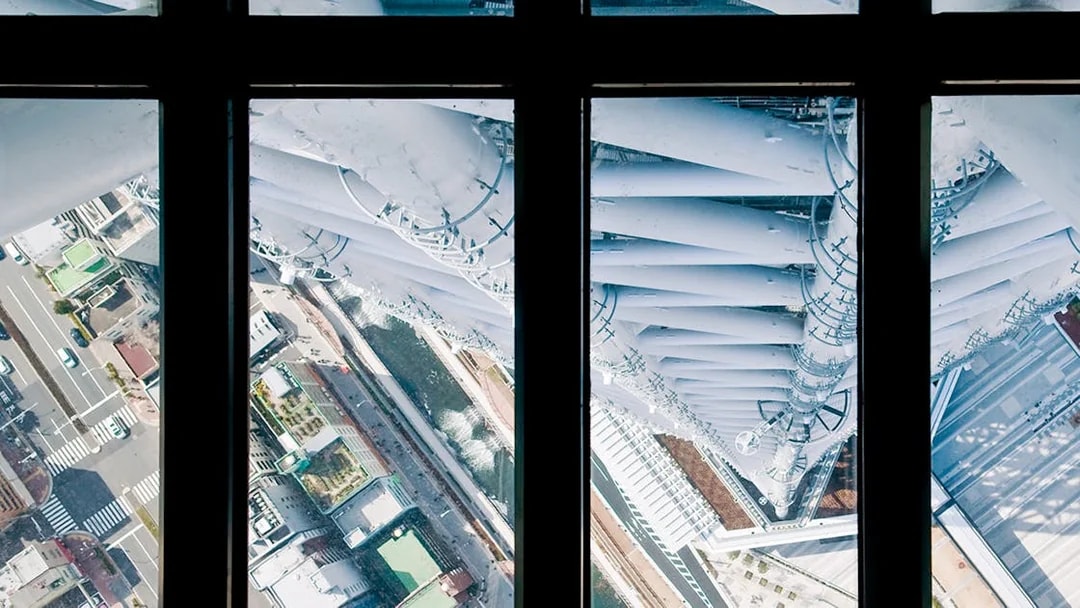 View from Tokyo Skytree observation deck overlooking city streets below.
