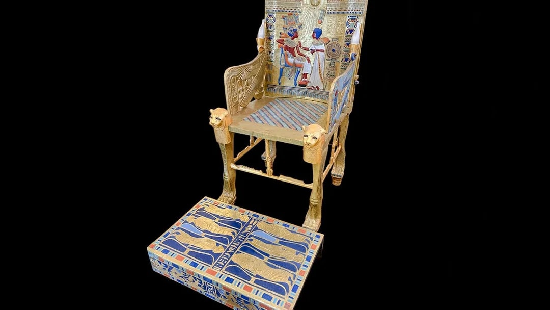 Golden throne with intricate hieroglyphics and pharaoh imagery, Tomb of the Pharaohs.