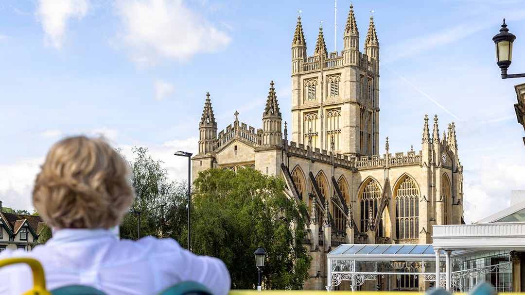 Visitor on Tootbus tour viewing Bath Abbey in Bath, England.