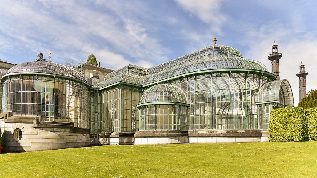 Royal Greenhouses at Laeken Castle, Brussels, with glass domes and lush garden.