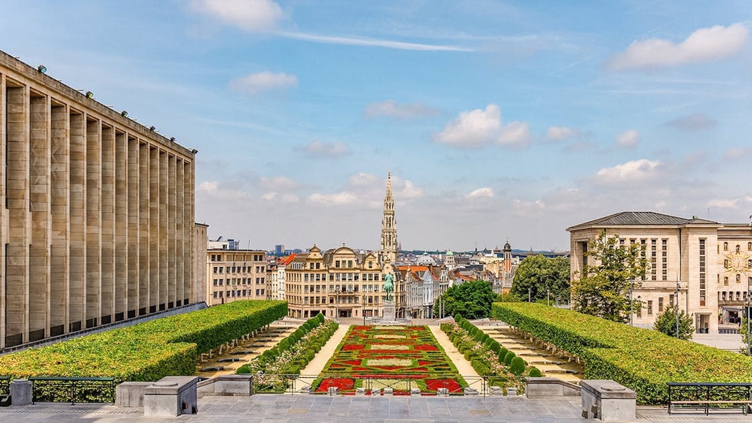 Mont des Arts garden with view of Brussels skyline and Town Hall tower.