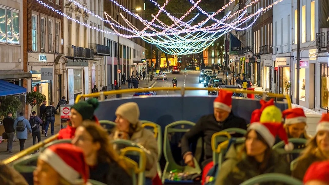 Double-decker bus touring London Christmas lights on Regent Street.