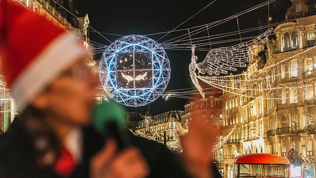 London Christmas lights and red bus on Tootbus tour at night.