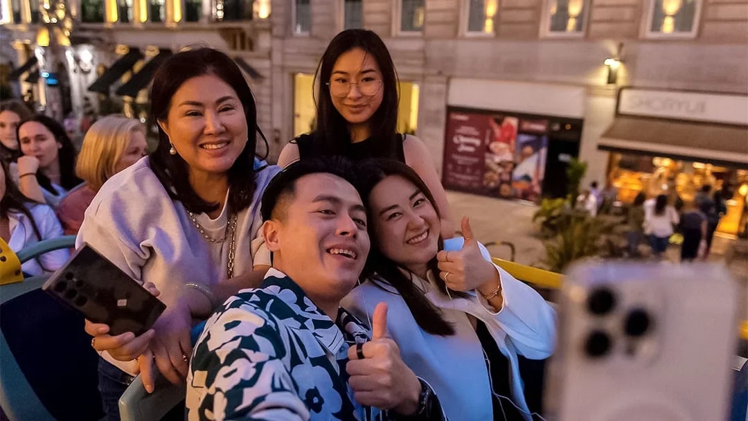 Group enjoying a night tour on a double-decker bus in London.
