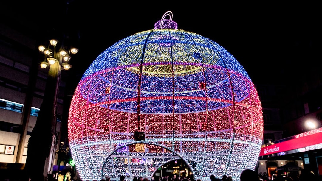 Giant illuminated Christmas ornament in Paris street.