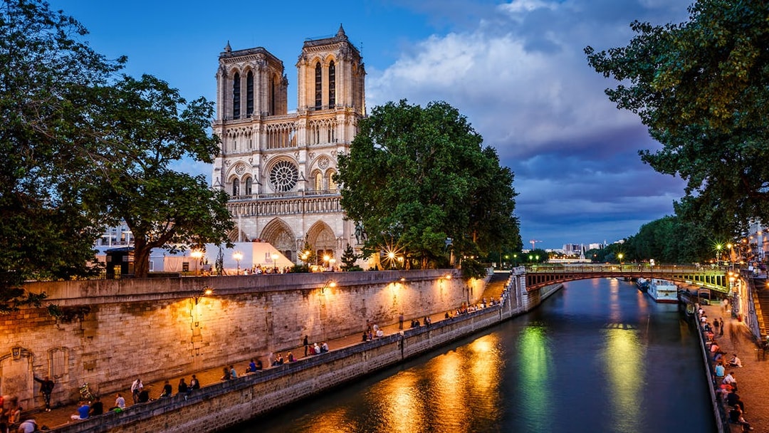 Notre Dame Cathedral and Seine River at dusk in Paris.