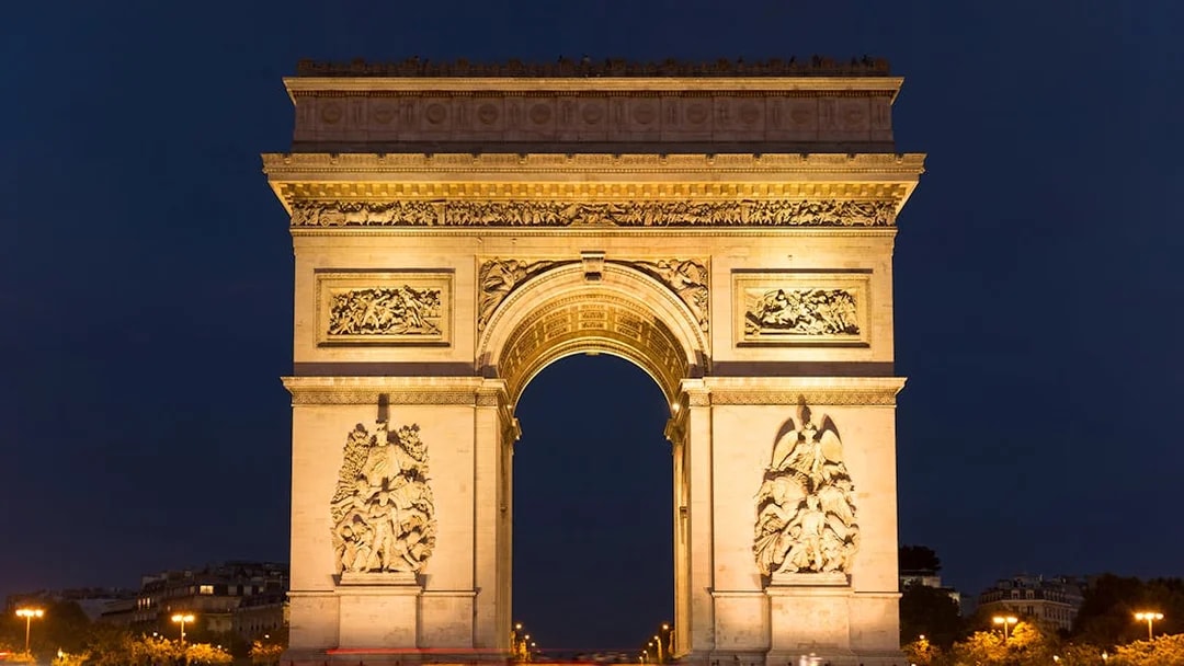 Arc de Triomphe illuminated at night, Paris Hop-On Hop-Off Bus Tour.