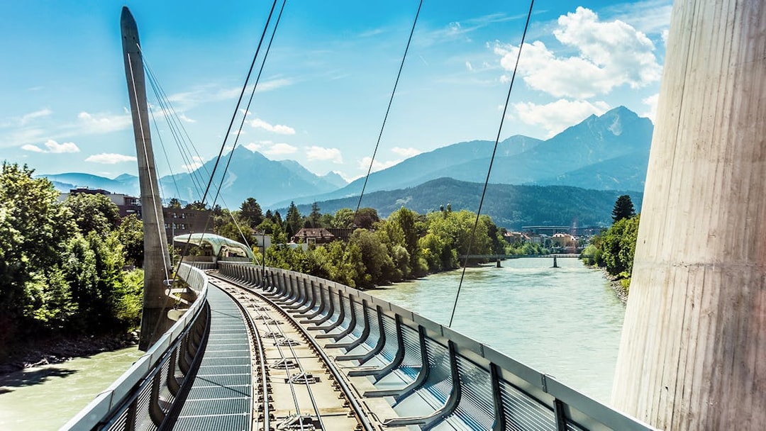 Railway bridge over the Inn River with Nordkette mountains in Innsbruck, Austria.