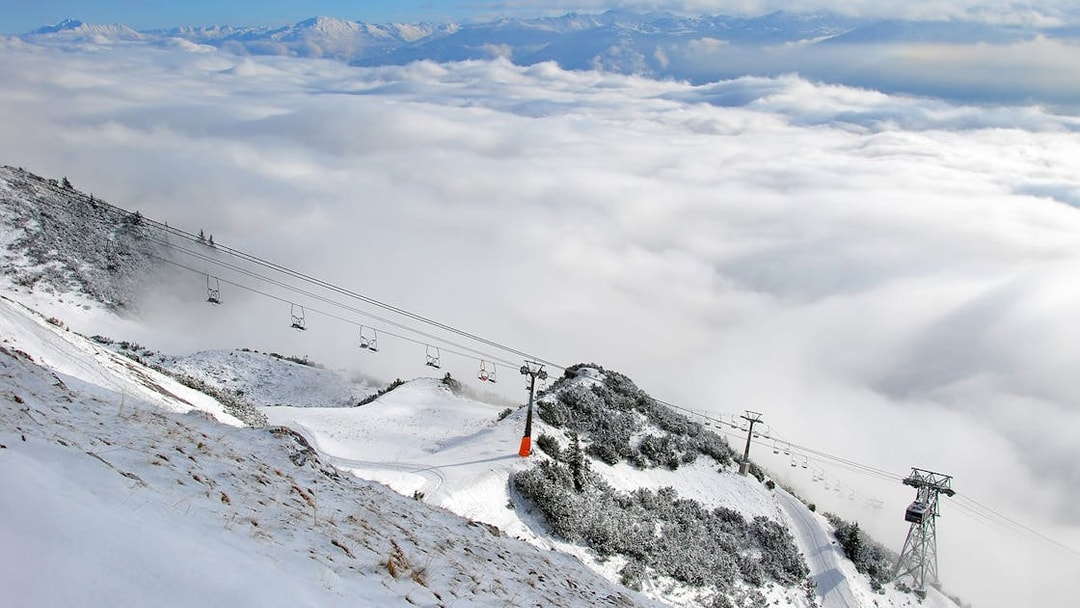 Nordkettenbahn cable car ascending snowy mountain in Innsbruck, Austria.