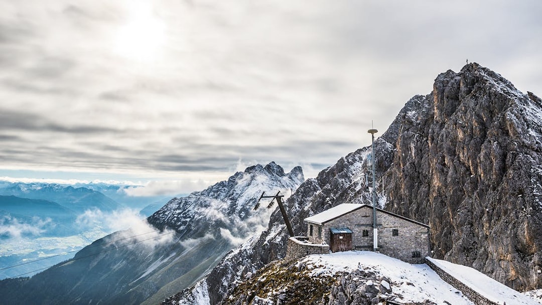 Nordkettenbahn summit view with snow-covered peaks and a mountain hut in Innsbruck.