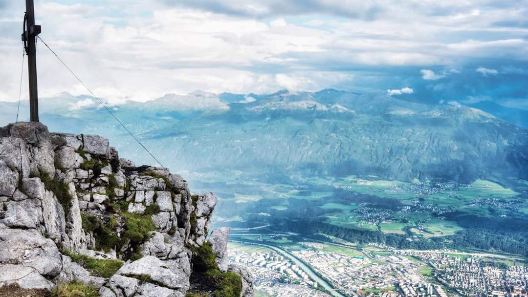 View from Nordkettenbahn summit overlooking Innsbruck and surrounding mountains.