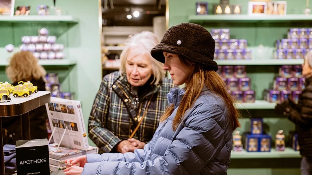 Visitors browsing souvenirs at Top of the Rock gift shop, New York City.