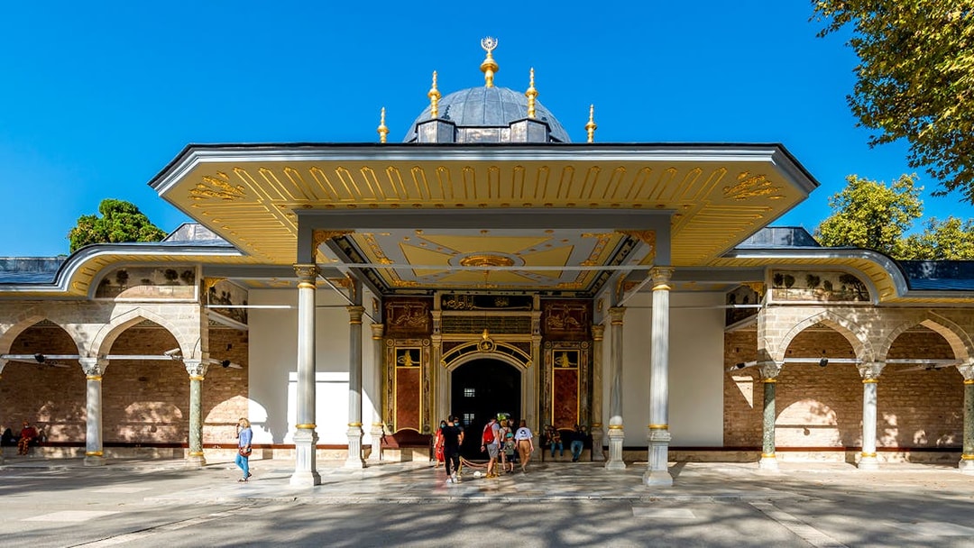 Gate of Felicity entrance at Topkapi Palace, Istanbul, with visitors exploring the historic site.