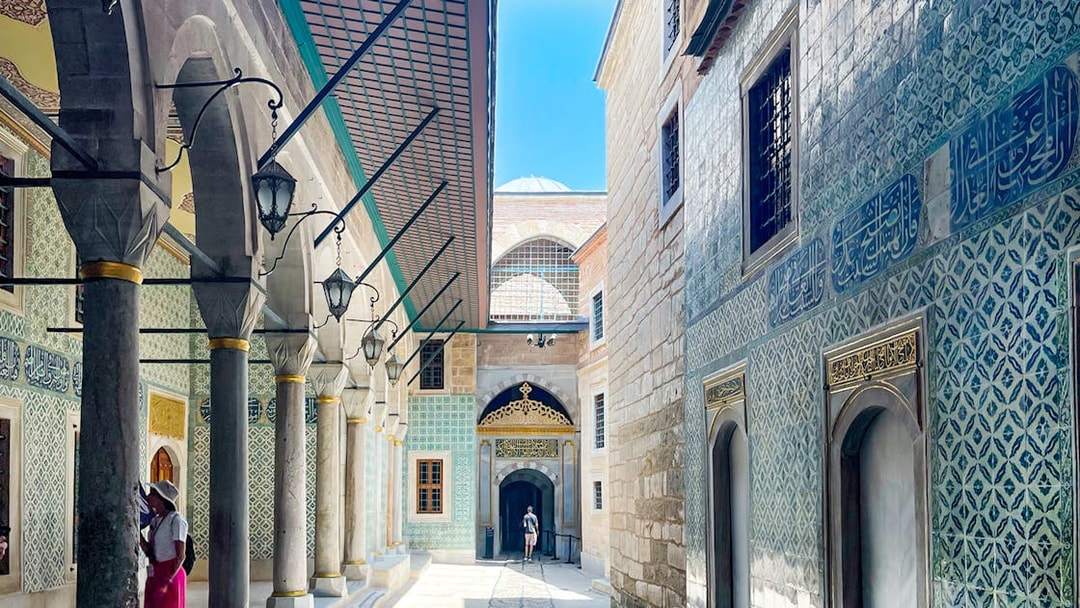 Topkapi Palace courtyard with ornate tile walls and arched walkway, Istanbul.