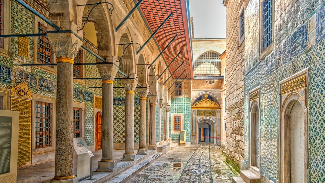 Topkapi Palace ornate corridor with arches and intricate tilework, Istanbul.