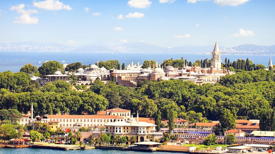 Topkapi Palace surrounded by lush greenery with the Bosphorus in the background, Istanbul.