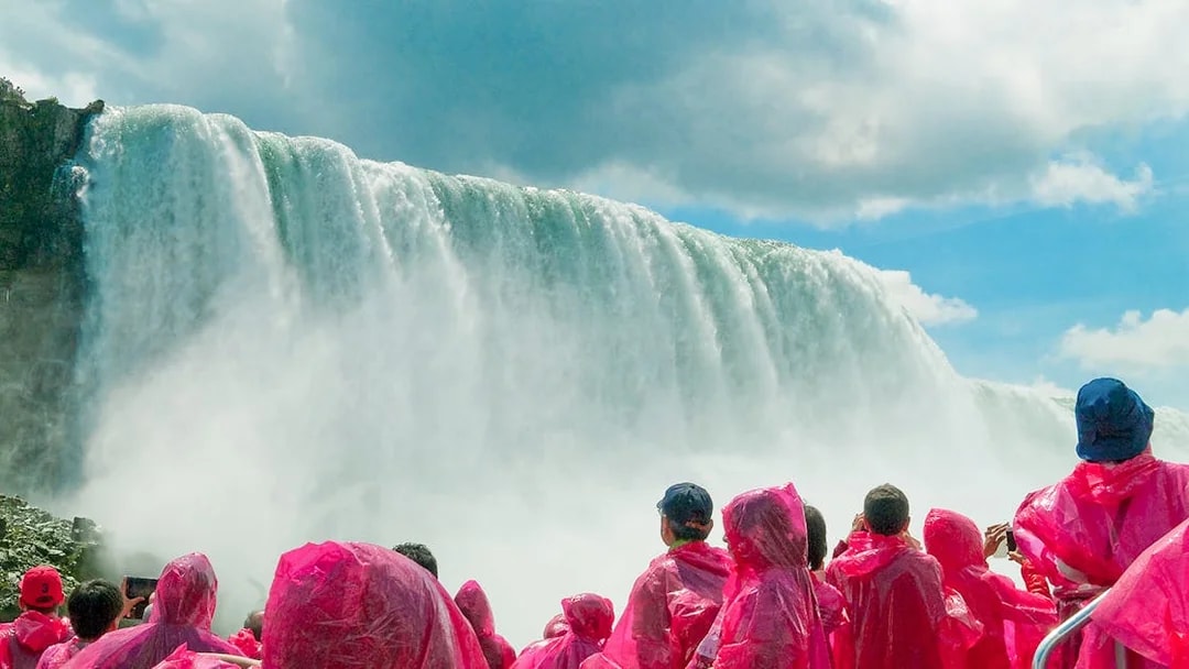 Tourists in pink ponchos on a boat cruise near Niagara Falls.