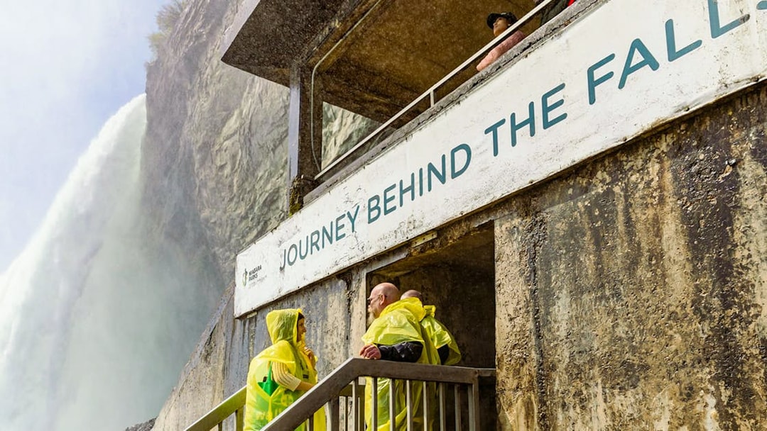 People in yellow ponchos at Journey Behind the Falls, Niagara Falls.