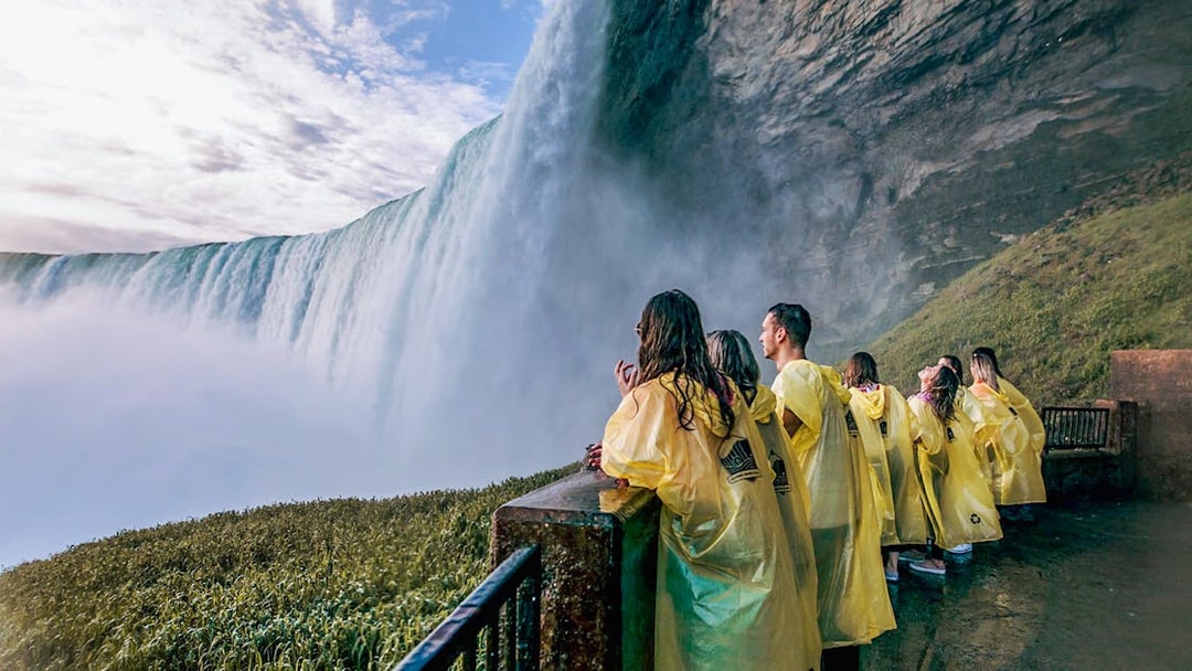 Visitors in yellow ponchos at a Niagara Falls viewpoint.