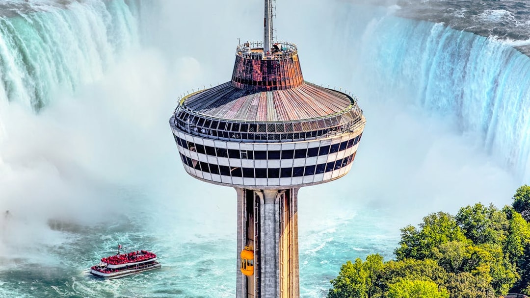 Skylon Tower observation deck overlooking Niagara Falls with a boat in the water below.