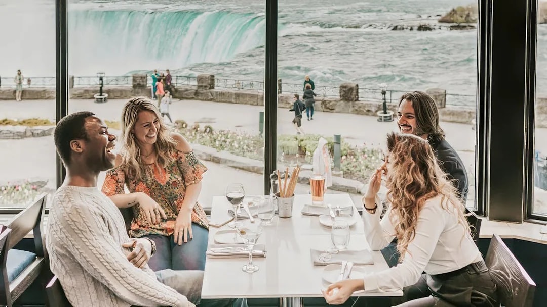 Dining with a view of Niagara Falls on a Toronto day tour with Hornblower Cruise.