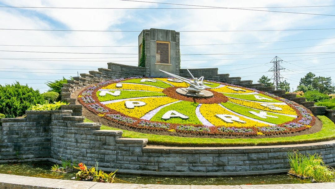 Floral Clock at Niagara Parks with colorful flower design and stone border.