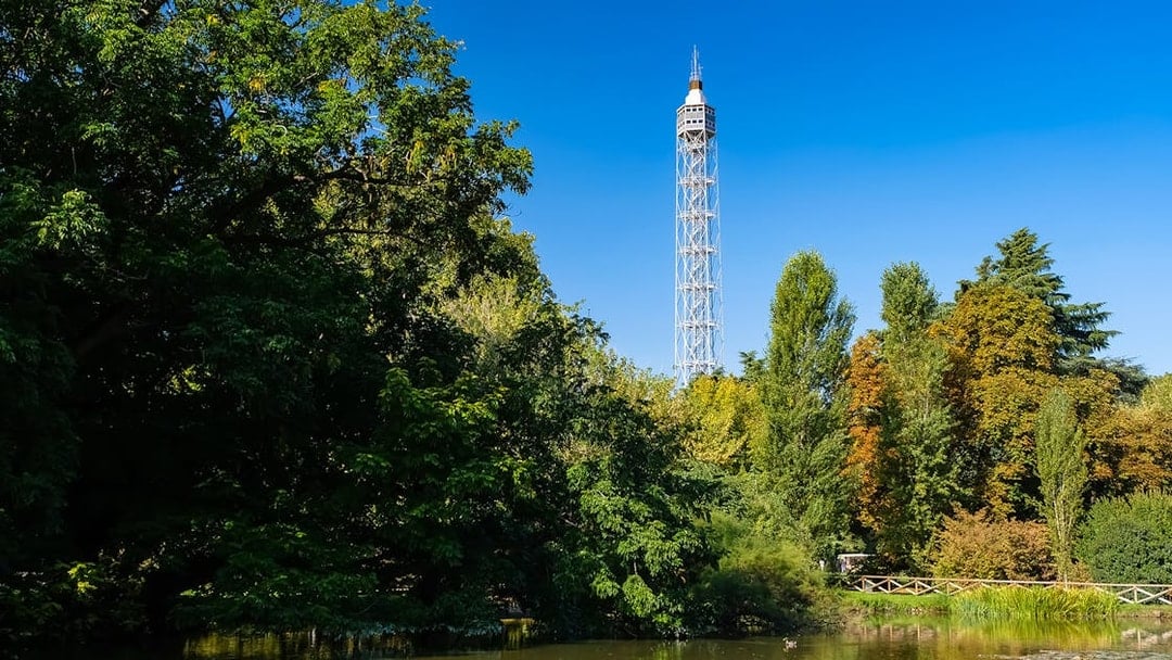 Torre Branca rising above lush trees in Milan's Sempione Park.