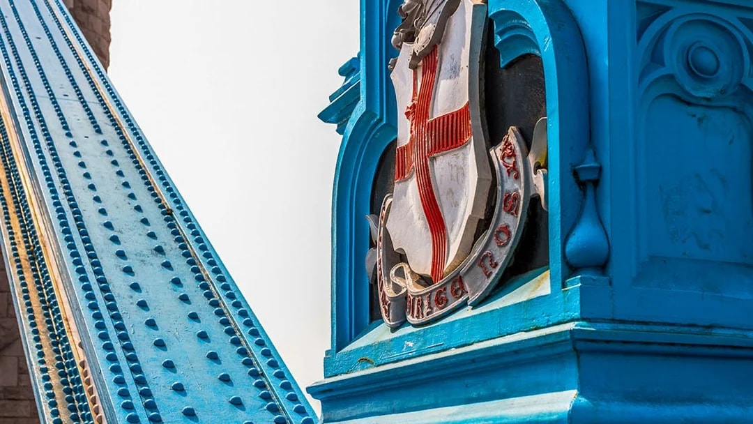 Tower Bridge close-up of blue structure and emblem, London.